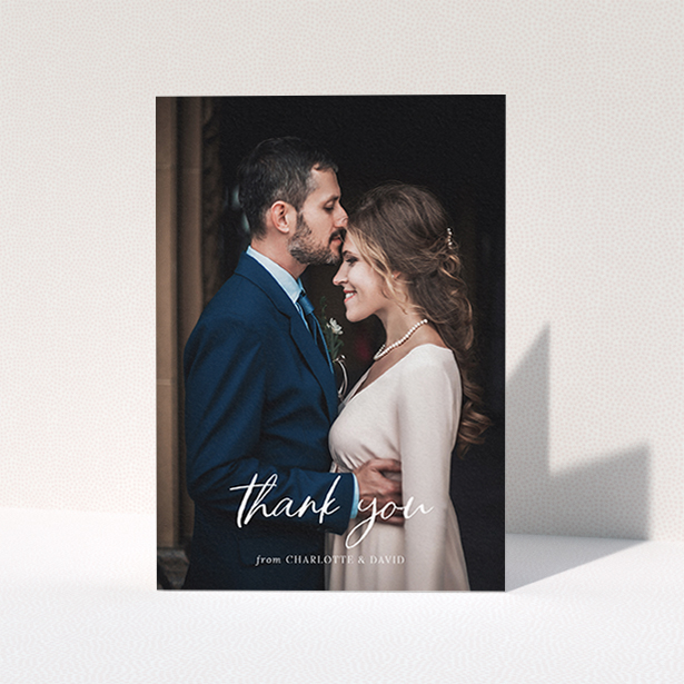 A wedding thank you card design called "Calligraphy Thanks". It is an A6 card in a portrait orientation. It is a photographic wedding thank you card with room for 1 photo. "Calligraphy Thanks" is available as a folded card, with mainly white colouring.