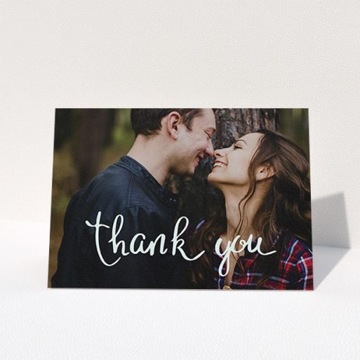 A wedding thank you card design called "Curly thank you". It is an A6 card in a landscape orientation. It is a photographic wedding thank you card with room for 1 photo. "Curly thank you" is available as a folded card, with mainly white colouring.