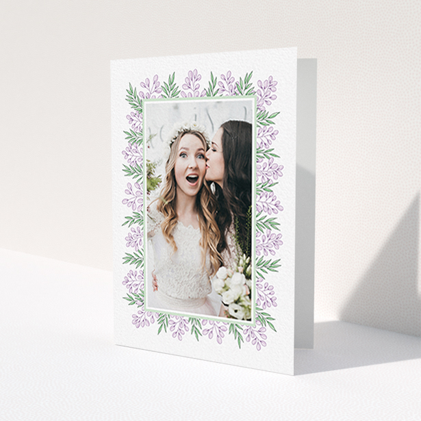 A wedding thank you card called 'Floral Thank You Card'. It is an A6 card in a portrait orientation. It is a photographic wedding thank you card with room for 1 photo. 'Floral Thank You Card' is available as a folded card, with tones of purple and green.