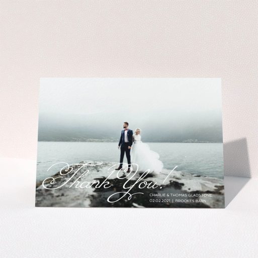 A wedding thank you card named "Flourished Thank You". It is an A5 card in a landscape orientation. It is a photographic wedding thank you card with room for 1 photo. "Flourished Thank You" is available as a folded card, with mainly white colouring.