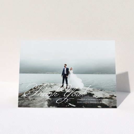 A wedding thank you card named "Flourished Thank You". It is an A5 card in a landscape orientation. It is a photographic wedding thank you card with room for 1 photo. "Flourished Thank You" is available as a folded card, with mainly white colouring.
