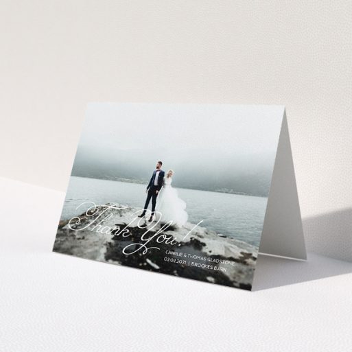 A wedding thank you card named 'Flourished Thank You'. It is an A5 card in a landscape orientation. It is a photographic wedding thank you card with room for 1 photo. 'Flourished Thank You' is available as a folded card, with mainly white colouring.