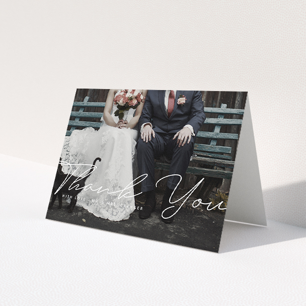 A wedding thank you card design named 'Hermes'. It is an A5 card in a landscape orientation. It is a photographic wedding thank you card with room for 1 photo. 'Hermes' is available as a folded card, with mainly white colouring.