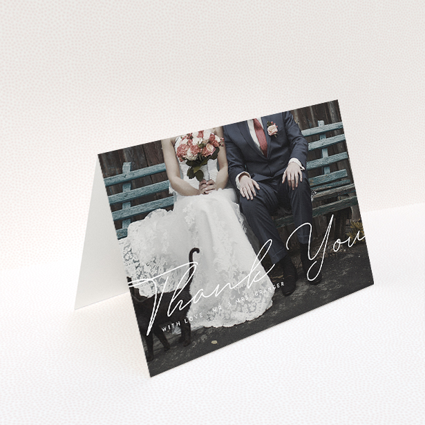 A wedding thank you card design named "Hermes". It is an A5 card in a landscape orientation. It is a photographic wedding thank you card with room for 1 photo. "Hermes" is available as a folded card, with mainly white colouring.