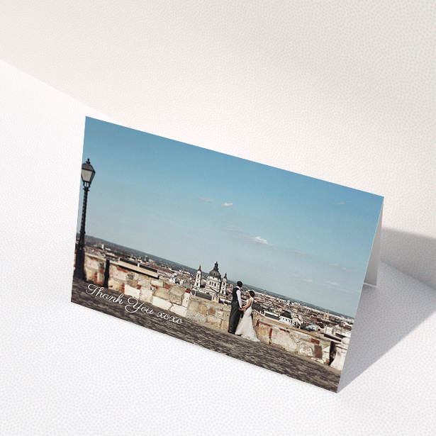 A wedding thank you card named "Italianno". It is an A5 card in a landscape orientation. It is a photographic wedding thank you card with room for 1 photo. "Italianno" is available as a folded card, with mainly white colouring.