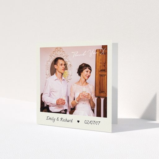 A wedding thank you card named 'Keepsake'. It is a square (148mm x 148mm) card in a square orientation. It is a photographic wedding thank you card with room for 1 photo. 'Keepsake' is available as a folded card, with tones of cream and navy blue.