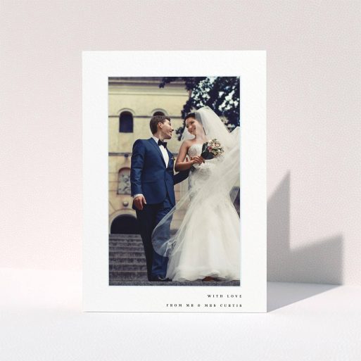 A wedding thank you card design named "Little blue border". It is an A5 card in a portrait orientation. It is a photographic wedding thank you card with room for 1 photo. "Little blue border" is available as a folded card, with mainly white colouring.