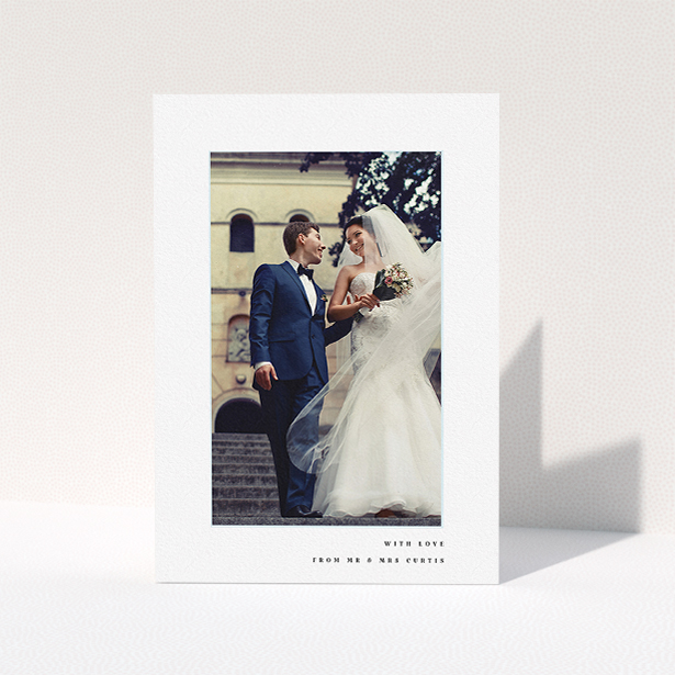 A wedding thank you card design named "Little blue border". It is an A5 card in a portrait orientation. It is a photographic wedding thank you card with room for 1 photo. "Little blue border" is available as a folded card, with mainly white colouring.