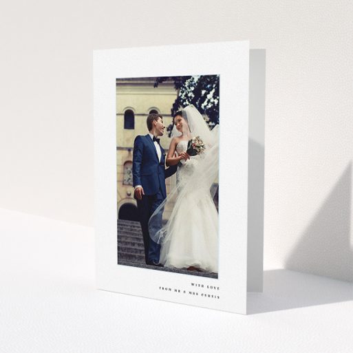 A wedding thank you card design named 'Little blue border'. It is an A5 card in a portrait orientation. It is a photographic wedding thank you card with room for 1 photo. 'Little blue border' is available as a folded card, with mainly white colouring.