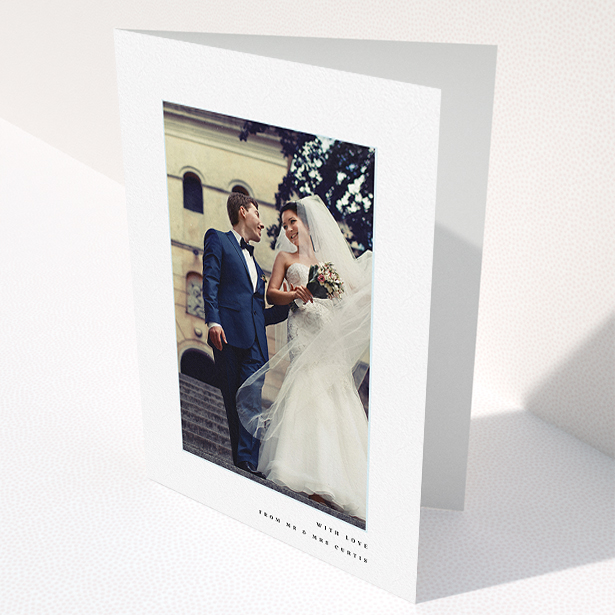 A wedding thank you card design named "Little blue border". It is an A5 card in a portrait orientation. It is a photographic wedding thank you card with room for 1 photo. "Little blue border" is available as a folded card, with mainly white colouring.