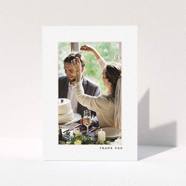 A wedding thank you card design named "Little pink border". It is an A6 card in a portrait orientation. It is a photographic wedding thank you card with room for 1 photo. "Little pink border" is available as a folded card, with mainly white colouring.