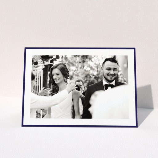 A wedding thank you card named "Navy Border". It is an A5 card in a landscape orientation. It is a photographic wedding thank you card with room for 1 photo. "Navy Border" is available as a folded card, with tones of blue and white.