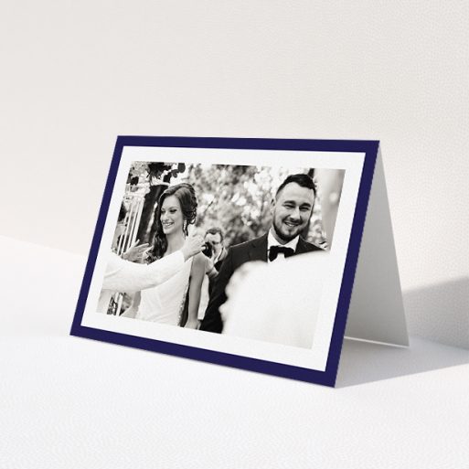 A wedding thank you card named 'Navy Border'. It is an A5 card in a landscape orientation. It is a photographic wedding thank you card with room for 1 photo. 'Navy Border' is available as a folded card, with tones of blue and white.