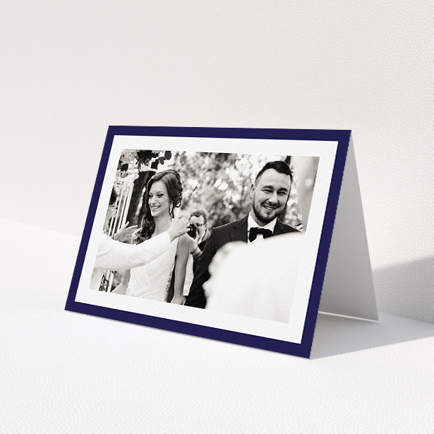 A wedding thank you card named "Navy Border". It is an A5 card in a landscape orientation. It is a photographic wedding thank you card with room for 1 photo. "Navy Border" is available as a folded card, with tones of blue and white.