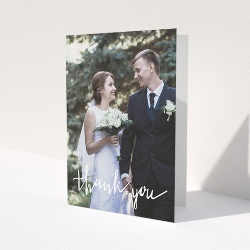 A wedding thank you card called 'New to calligraphy'. It is an A5 card in a portrait orientation. It is a photographic wedding thank you card with room for 1 photo. 'New to calligraphy' is available as a folded card, with mainly white colouring.