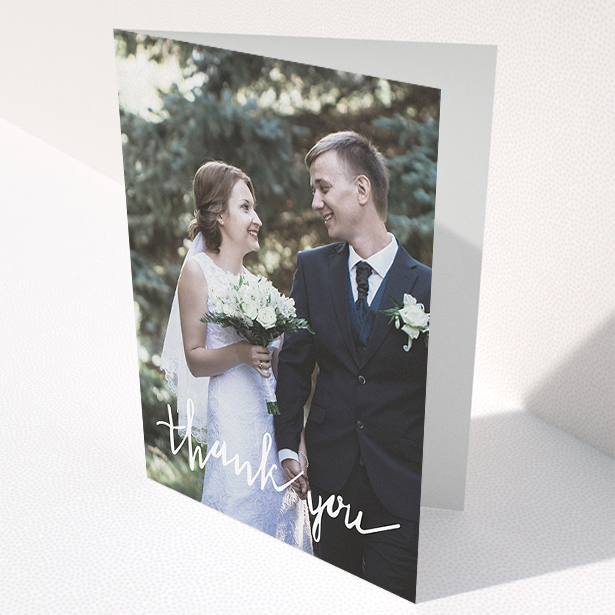 A wedding thank you card called "New to calligraphy". It is an A5 card in a portrait orientation. It is a photographic wedding thank you card with room for 1 photo. "New to calligraphy" is available as a folded card, with mainly white colouring.