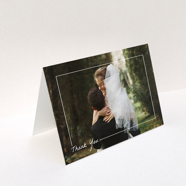 A wedding thank you card called "On Photo Border". It is an A5 card in a landscape orientation. It is a photographic wedding thank you card with room for 1 photo. "On Photo Border" is available as a folded card, with mainly white colouring.