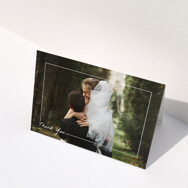 A wedding thank you card called "On Photo Border". It is an A5 card in a landscape orientation. It is a photographic wedding thank you card with room for 1 photo. "On Photo Border" is available as a folded card, with mainly white colouring.