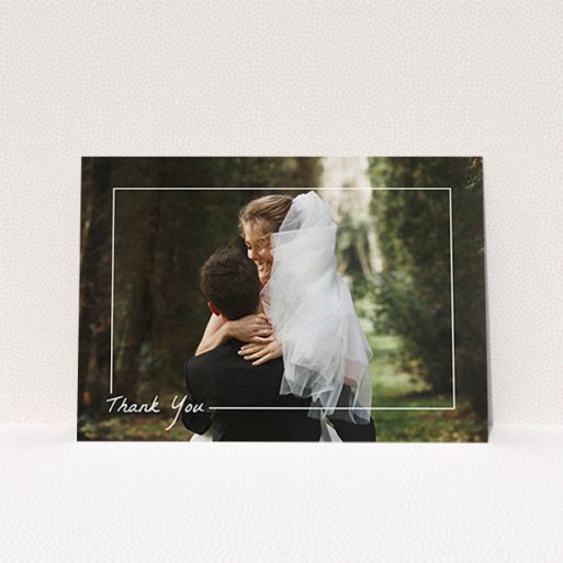A wedding thank you card design called "On Photo Border". It is an A6 card in a landscape orientation. It is a photographic wedding thank you card with room for 1 photo. "On Photo Border" is available as a flat card, with mainly white colouring.