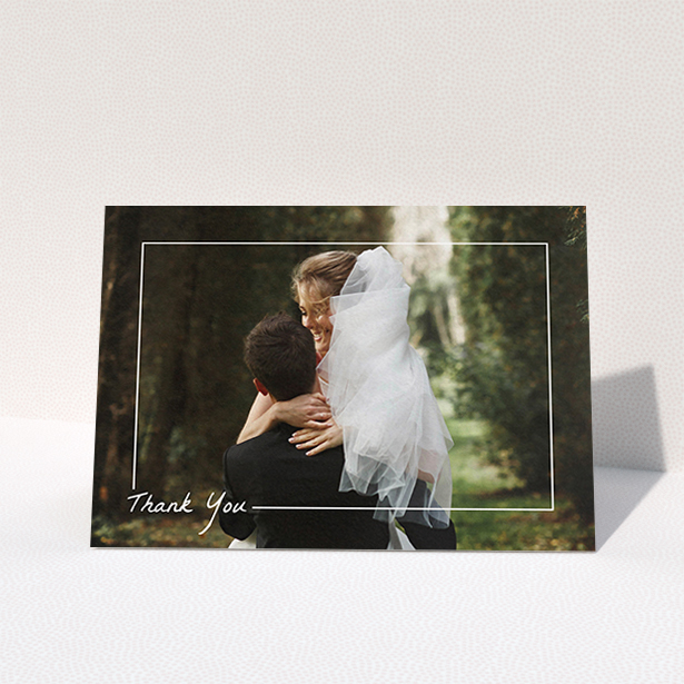 A wedding thank you card template titled "On Photo Border". It is an A6 card in a landscape orientation. It is a photographic wedding thank you card with room for 1 photo. "On Photo Border" is available as a folded card, with mainly white colouring.