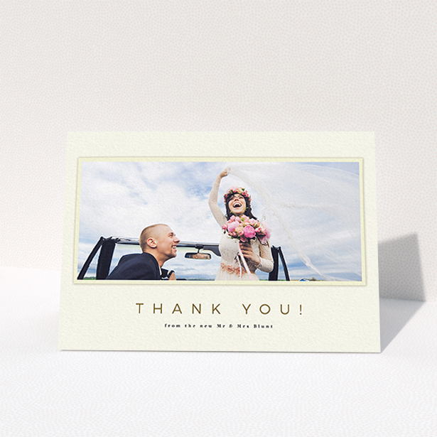 A wedding thank you card template titled "One white Polaroid ". It is an A6 card in a landscape orientation. It is a photographic wedding thank you card with room for 1 photo. "One white Polaroid " is available as a folded card, with mainly cream colouring.
