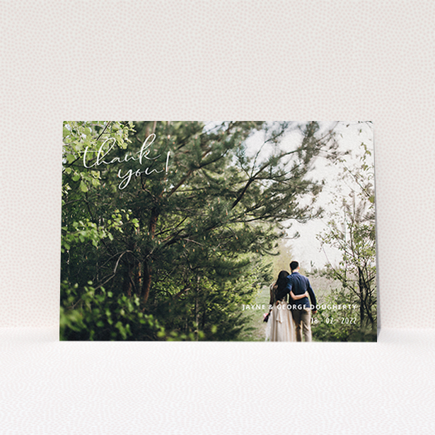A wedding thank you card called "Opposite Photo Corners". It is an A6 card in a landscape orientation. It is a photographic wedding thank you card with room for 1 photo. "Opposite Photo Corners" is available as a flat card, with mainly white colouring.