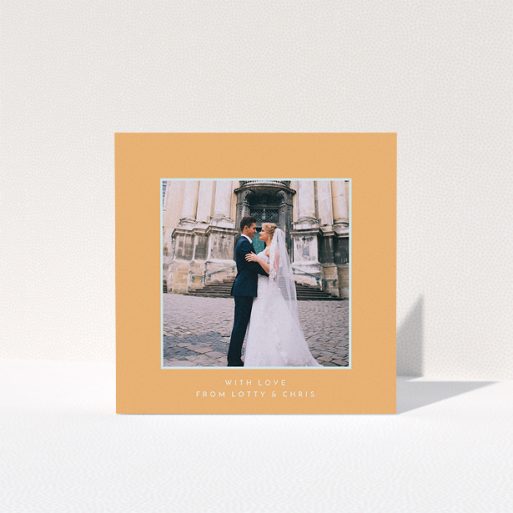 A wedding thank you card named "Orange and blue". It is a square (148mm x 148mm) card in a square orientation. It is a photographic wedding thank you card with room for 1 photo. "Orange and blue" is available as a folded card, with tones of orange and blue.