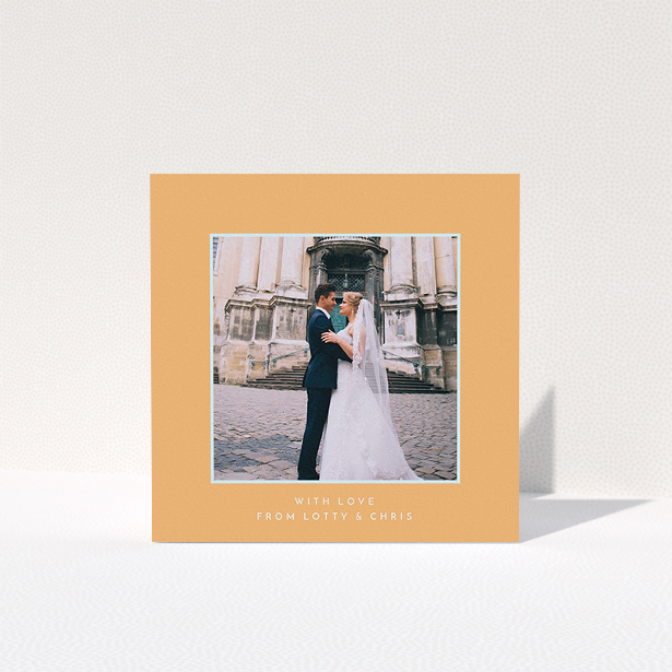 A wedding thank you card named "Orange and blue". It is a square (148mm x 148mm) card in a square orientation. It is a photographic wedding thank you card with room for 1 photo. "Orange and blue" is available as a folded card, with tones of orange and blue.