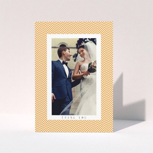 A wedding thank you card design called "Orange Houndstooth". It is an A6 card in a portrait orientation. It is a photographic wedding thank you card with room for 1 photo. "Orange Houndstooth" is available as a folded card, with tones of orange and white.