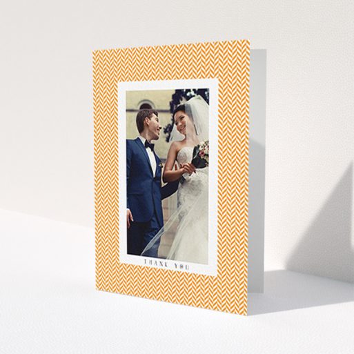 A wedding thank you card design called 'Orange Houndstooth'. It is an A6 card in a portrait orientation. It is a photographic wedding thank you card with room for 1 photo. 'Orange Houndstooth' is available as a folded card, with tones of orange and white.
