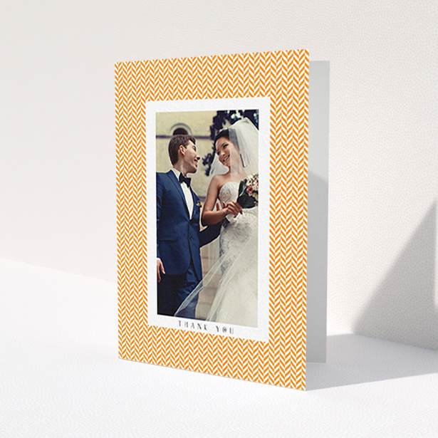 A wedding thank you card design called "Orange Houndstooth". It is an A6 card in a portrait orientation. It is a photographic wedding thank you card with room for 1 photo. "Orange Houndstooth" is available as a folded card, with tones of orange and white.
