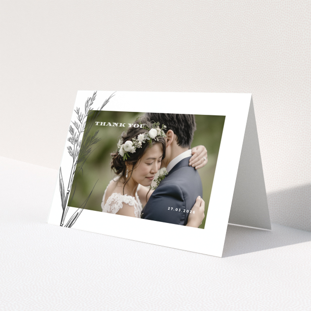 Wedding thank you card with one photo of a couple embracing, featuring floral design and wedding date.