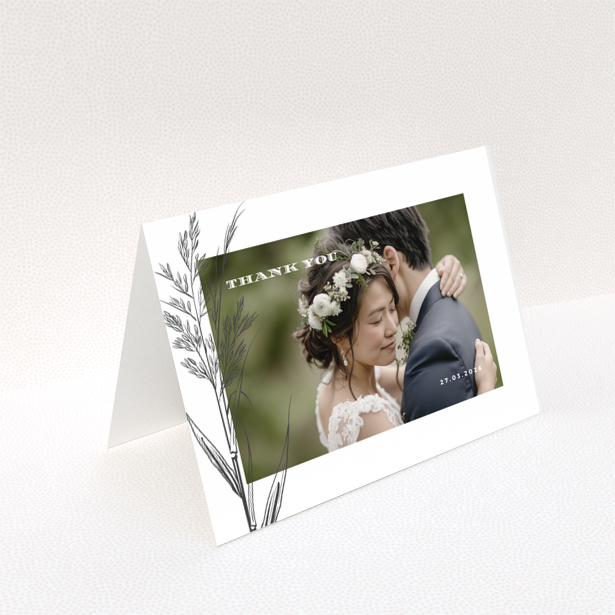 Wedding thank you card with one photo of a couple embracing, featuring floral design and wedding date.