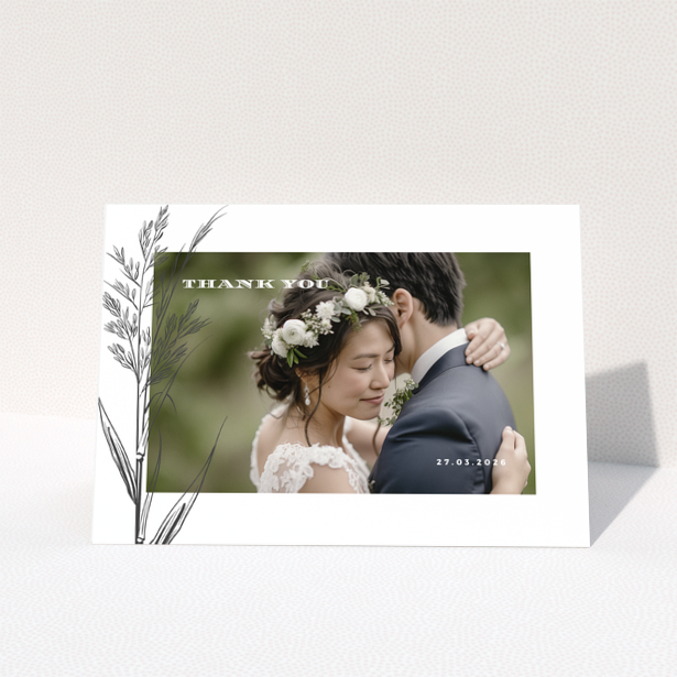 Wedding thank you card with one photo of a couple embracing, featuring floral design and wedding date.