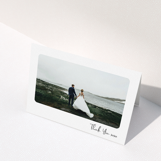 A wedding thank you card design called "Rounded Thanks". It is an A5 card in a landscape orientation. It is a photographic wedding thank you card with room for 1 photo. "Rounded Thanks" is available as a folded card, with mainly white colouring.