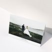 A wedding thank you card named "Sans Serif". It is an A5 card in a landscape orientation. It is a photographic wedding thank you card with room for 1 photo. "Sans Serif" is available as a folded card, with mainly white colouring.