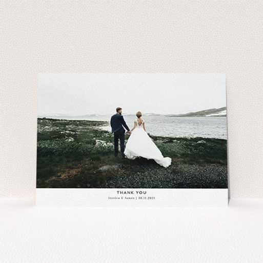 A wedding thank you card design named "Sans Serif". It is an A6 card in a landscape orientation. It is a photographic wedding thank you card with room for 1 photo. "Sans Serif" is available as a flat card, with mainly white colouring.