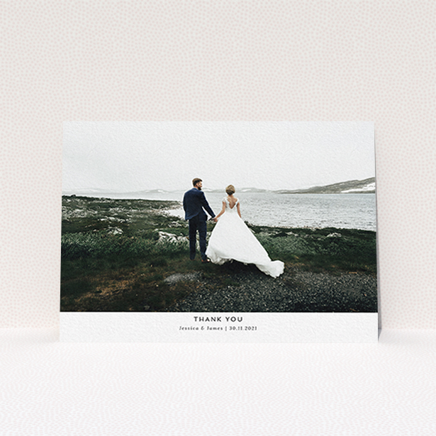 A wedding thank you card design named "Sans Serif". It is an A6 card in a landscape orientation. It is a photographic wedding thank you card with room for 1 photo. "Sans Serif" is available as a flat card, with mainly white colouring.
