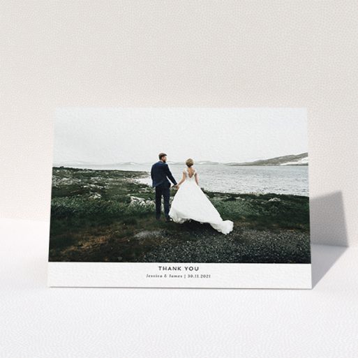 A wedding thank you card called "Sans Serif". It is an A6 card in a landscape orientation. It is a photographic wedding thank you card with room for 1 photo. "Sans Serif" is available as a folded card, with mainly white colouring.