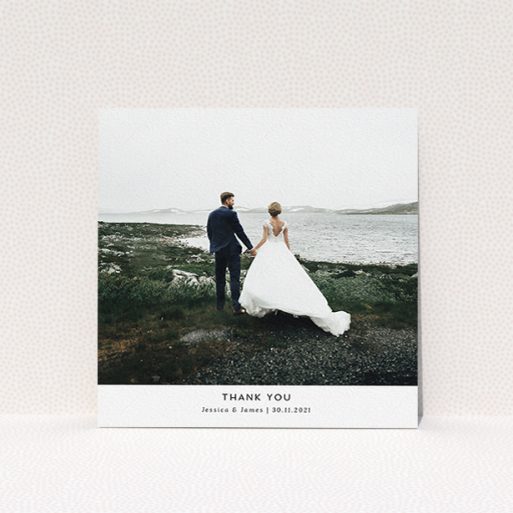 A wedding thank you card called "Sans Serif". It is a square (148mm x 148mm) card in a square orientation. It is a photographic wedding thank you card with room for 1 photo. "Sans Serif" is available as a flat card, with mainly white colouring.