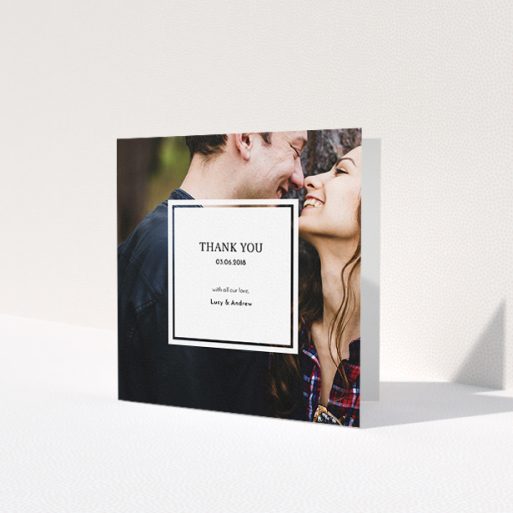 A wedding thank you card called 'Simple little square'. It is a square (148mm x 148mm) card in a square orientation. It is a photographic wedding thank you card with room for 1 photo. 'Simple little square' is available as a folded card, with mainly white colouring.