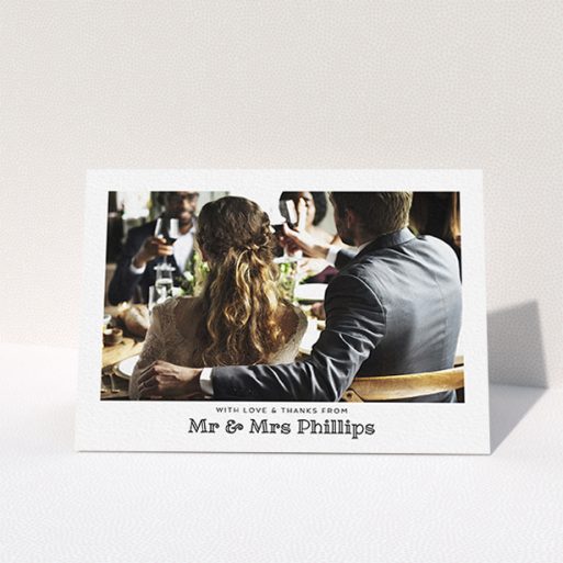 A wedding thank you card template titled "Simple Photo Frame". It is an A6 card in a landscape orientation. It is a photographic wedding thank you card with room for 1 photo. "Simple Photo Frame" is available as a folded card, with mainly white colouring.