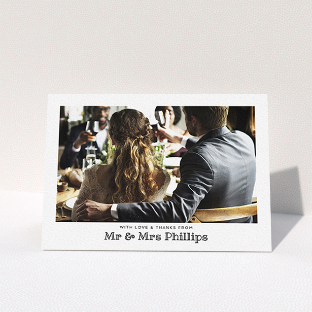 A wedding thank you card template titled "Simple Photo Frame". It is an A6 card in a landscape orientation. It is a photographic wedding thank you card with room for 1 photo. "Simple Photo Frame" is available as a folded card, with mainly white colouring.