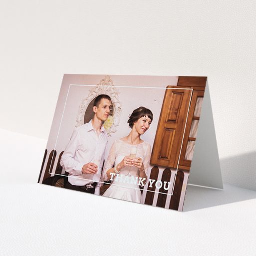 A wedding thank you card named 'Simple Thank You Frame'. It is an A6 card in a landscape orientation. It is a photographic wedding thank you card with room for 1 photo. 'Simple Thank You Frame' is available as a folded card, with mainly white colouring.