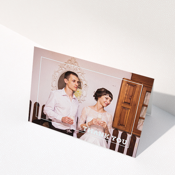 A wedding thank you card named "Simple Thank You Frame". It is an A6 card in a landscape orientation. It is a photographic wedding thank you card with room for 1 photo. "Simple Thank You Frame" is available as a folded card, with mainly white colouring.