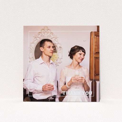 A wedding thank you card design named "Simple Thank You Frame". It is a square (148mm x 148mm) card in a square orientation. It is a photographic wedding thank you card with room for 1 photo. "Simple Thank You Frame" is available as a flat card, with mainly white colouring.