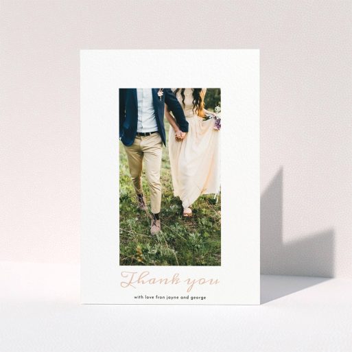 A wedding thank you card called "Small and Central". It is an A5 card in a portrait orientation. It is a photographic wedding thank you card with room for 1 photo. "Small and Central" is available as a folded card, with tones of white and pink.
