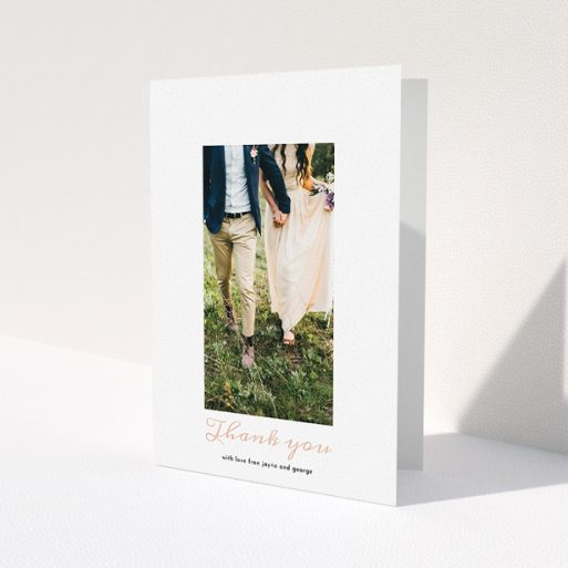 A wedding thank you card called 'Small and Central'. It is an A5 card in a portrait orientation. It is a photographic wedding thank you card with room for 1 photo. 'Small and Central' is available as a folded card, with tones of white and pink.