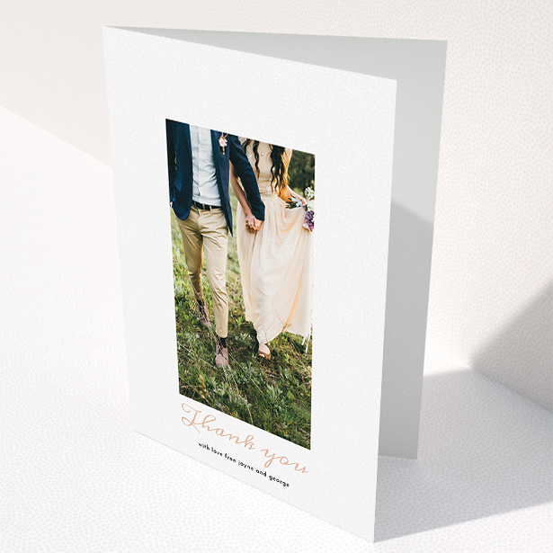 A wedding thank you card called "Small and Central". It is an A5 card in a portrait orientation. It is a photographic wedding thank you card with room for 1 photo. "Small and Central" is available as a folded card, with tones of white and pink.