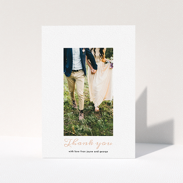 A wedding thank you card template titled "Small and Central". It is an A6 card in a portrait orientation. It is a photographic wedding thank you card with room for 1 photo. "Small and Central" is available as a folded card, with tones of white and pink.